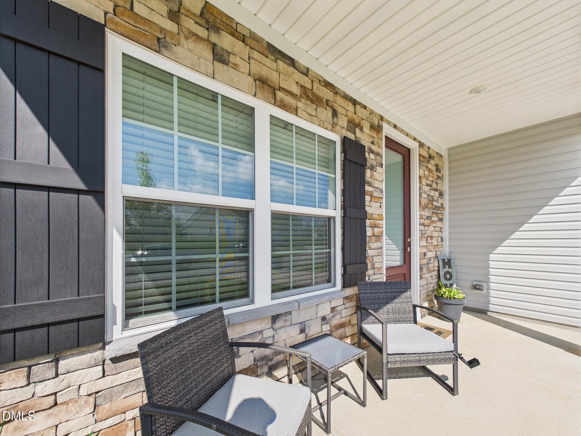 110 Symmetry Loop Youngsville, NC 27596 - Photo 8 of 72 a view of a patio with couple of chairs and a wooden fence