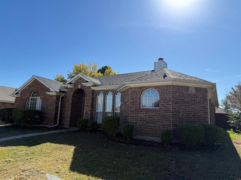 10931 Castle Drive Frisco, TX 75035 - Photo 2 of 14 a front view of a house with a yard