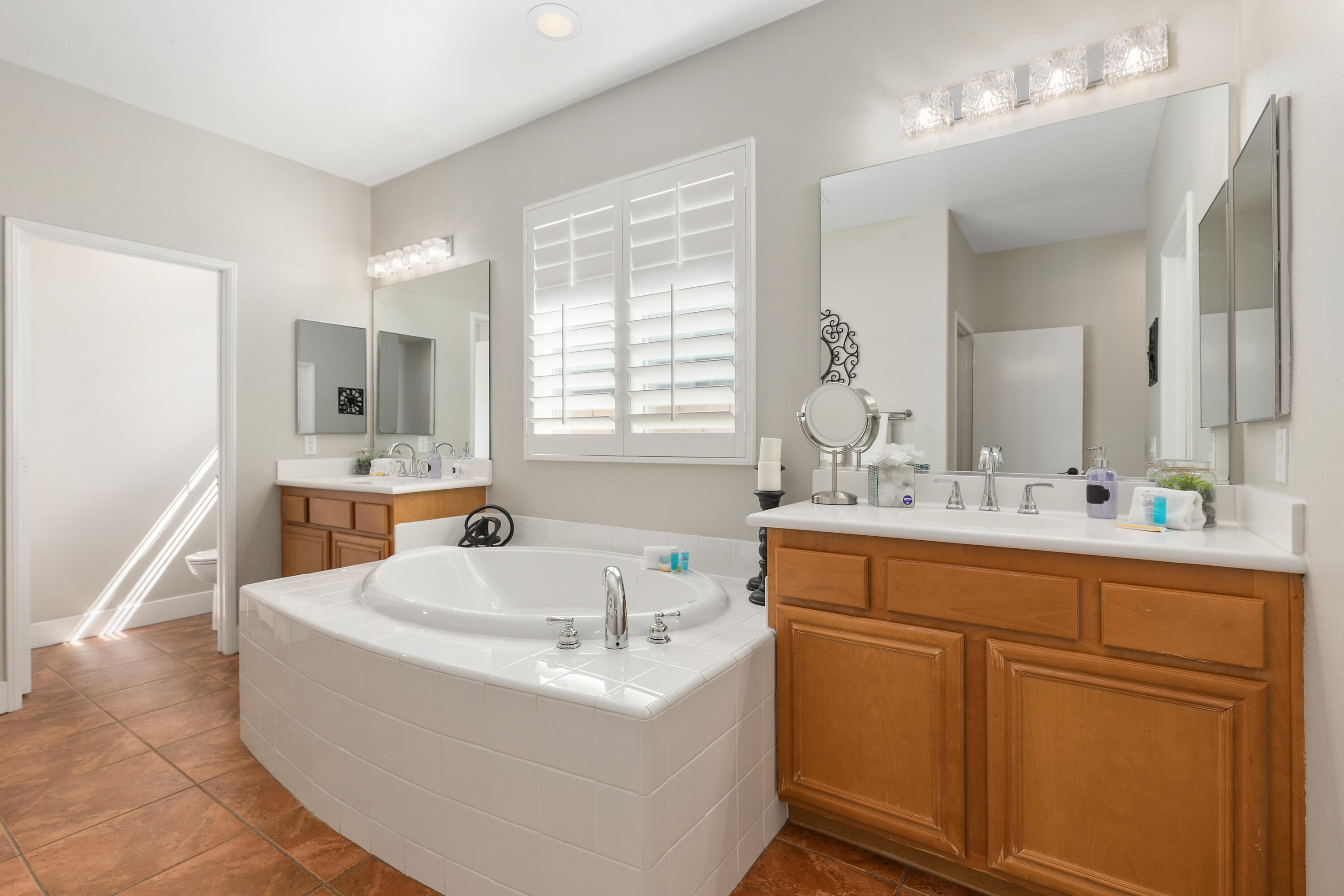49377 Biery Street Indio, CA 92201 - Photo 14 of 32 a bathroom with a sink double vanity mirror and bathtub