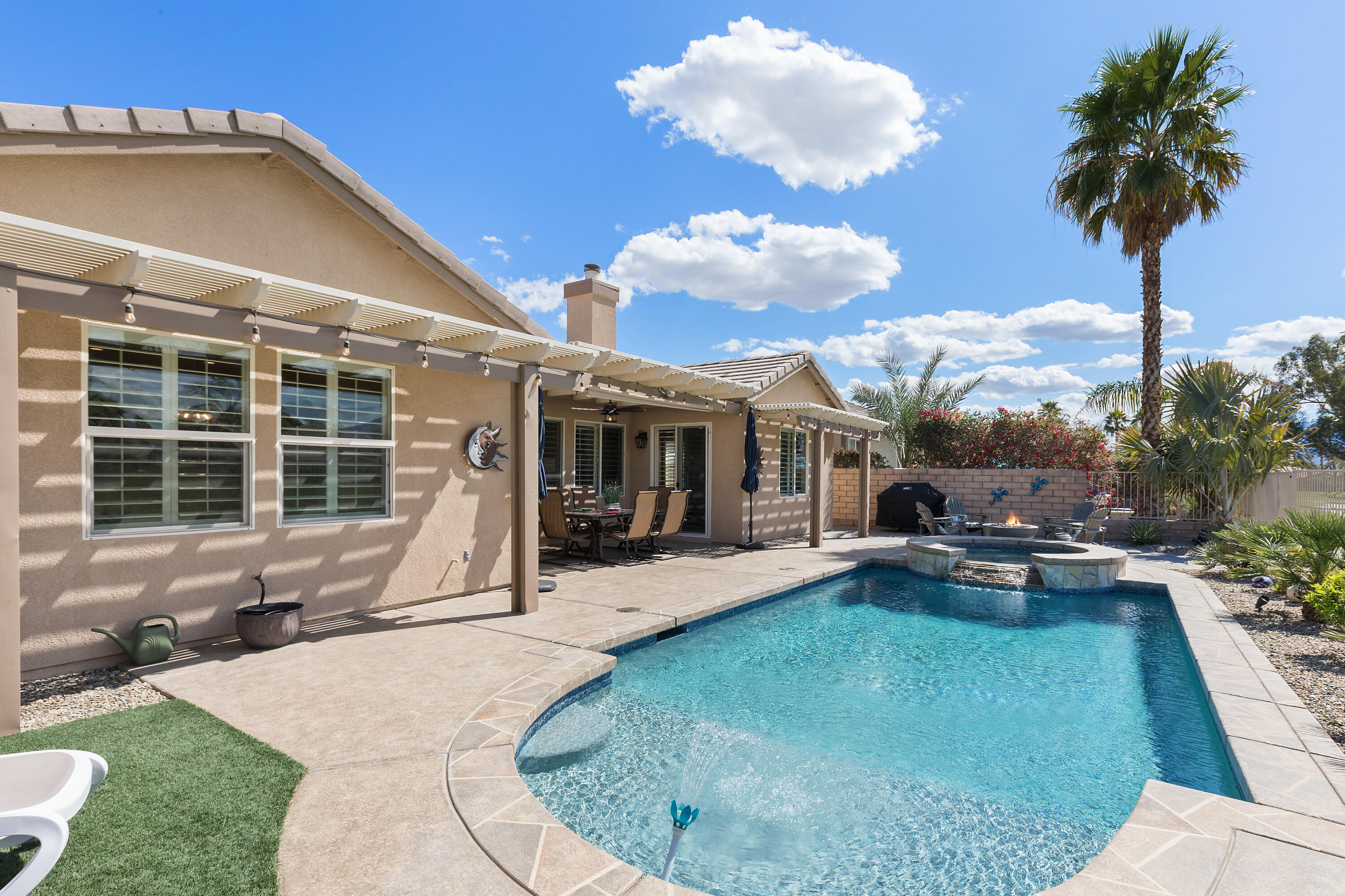 49377 Biery Street Indio, CA 92201 - Photo 23 of 32 a view of a house with backyard sitting area and garden