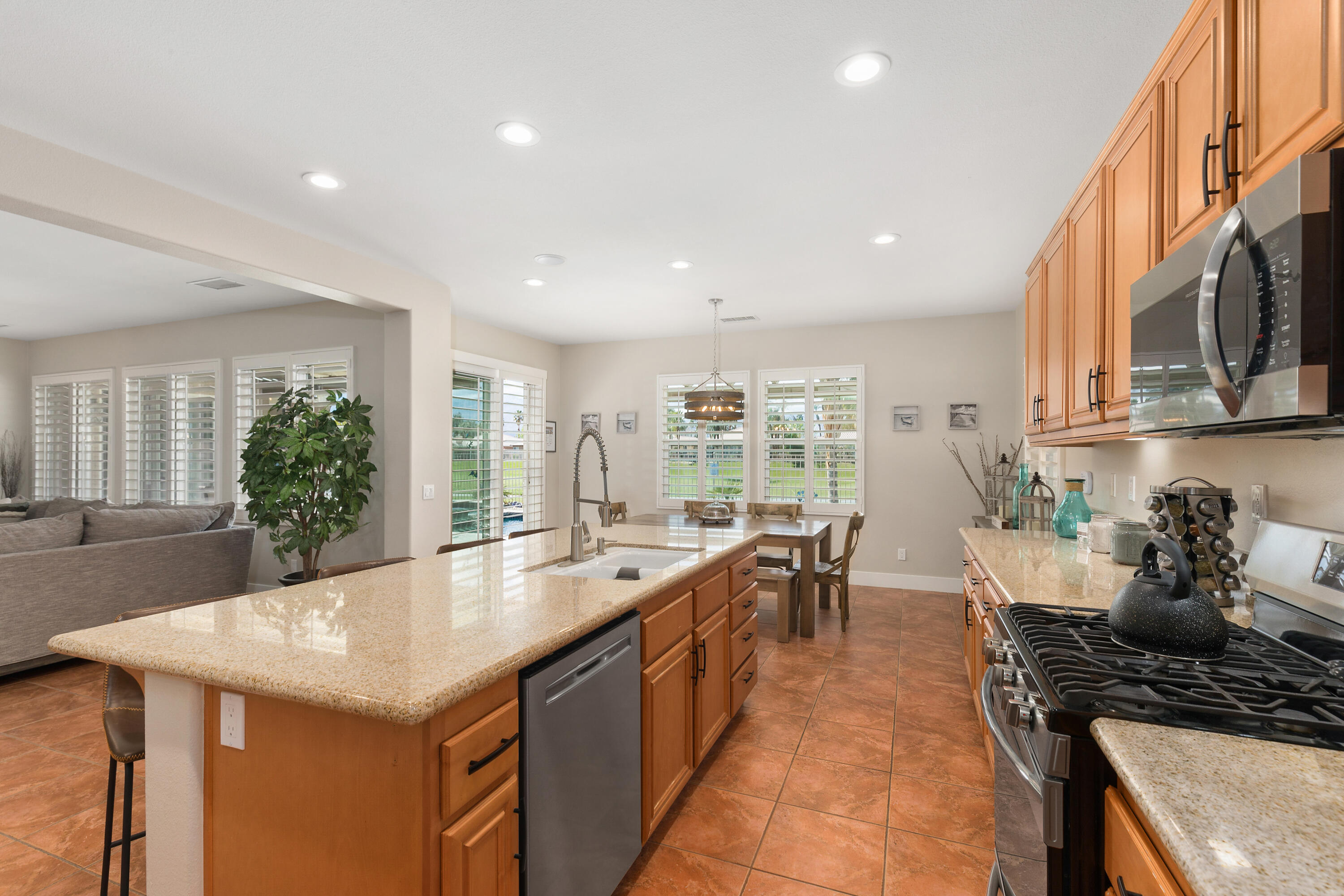 49377 Biery Street Indio, CA 92201 - Photo 9 of 32 a large kitchen with kitchen island a sink table and chairs