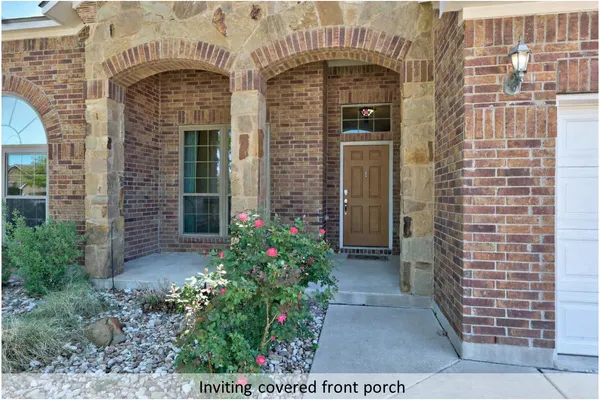 a front view of a house with plants