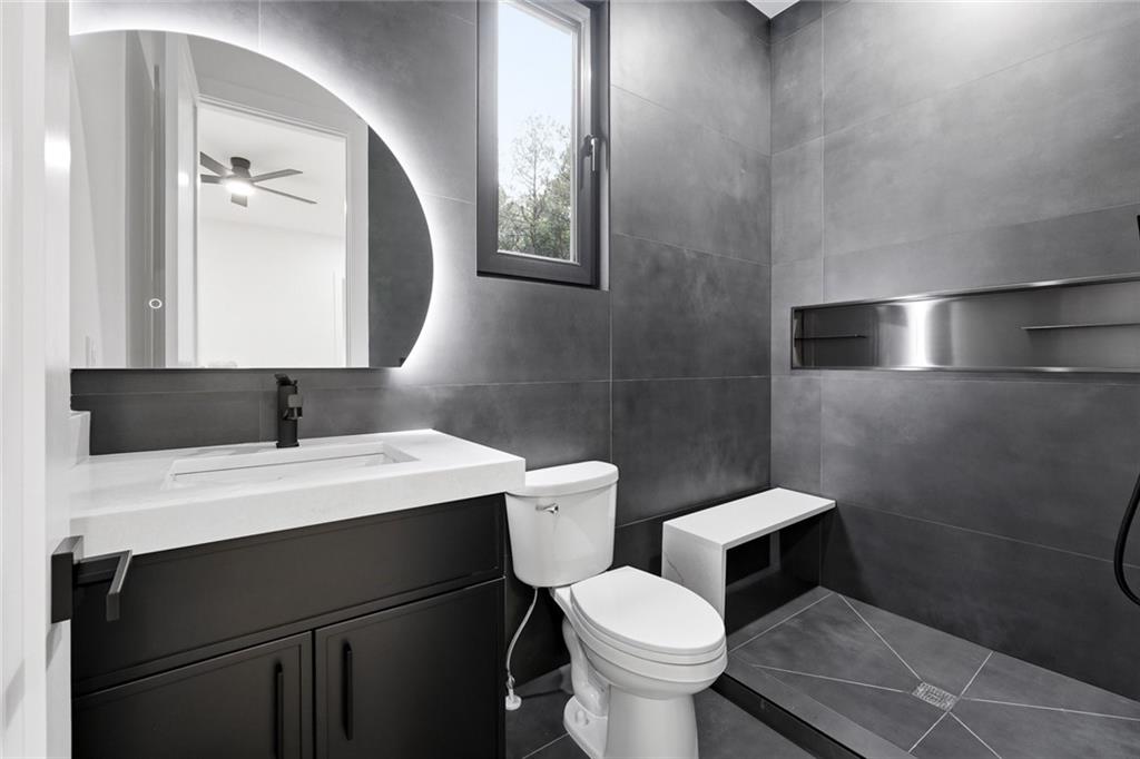 1563 Whitley Road Dacula, GA 30019 - Photo 32 of 44 a bathroom with a toilet sink and mirror
