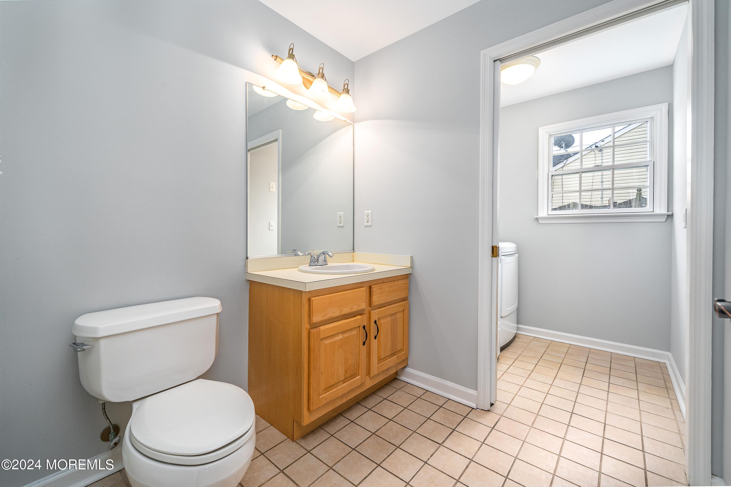 120 Leeward Road Manahawkin, NJ 08050 - Photo 14 of 23 a bathroom with a toilet sink and mirror
