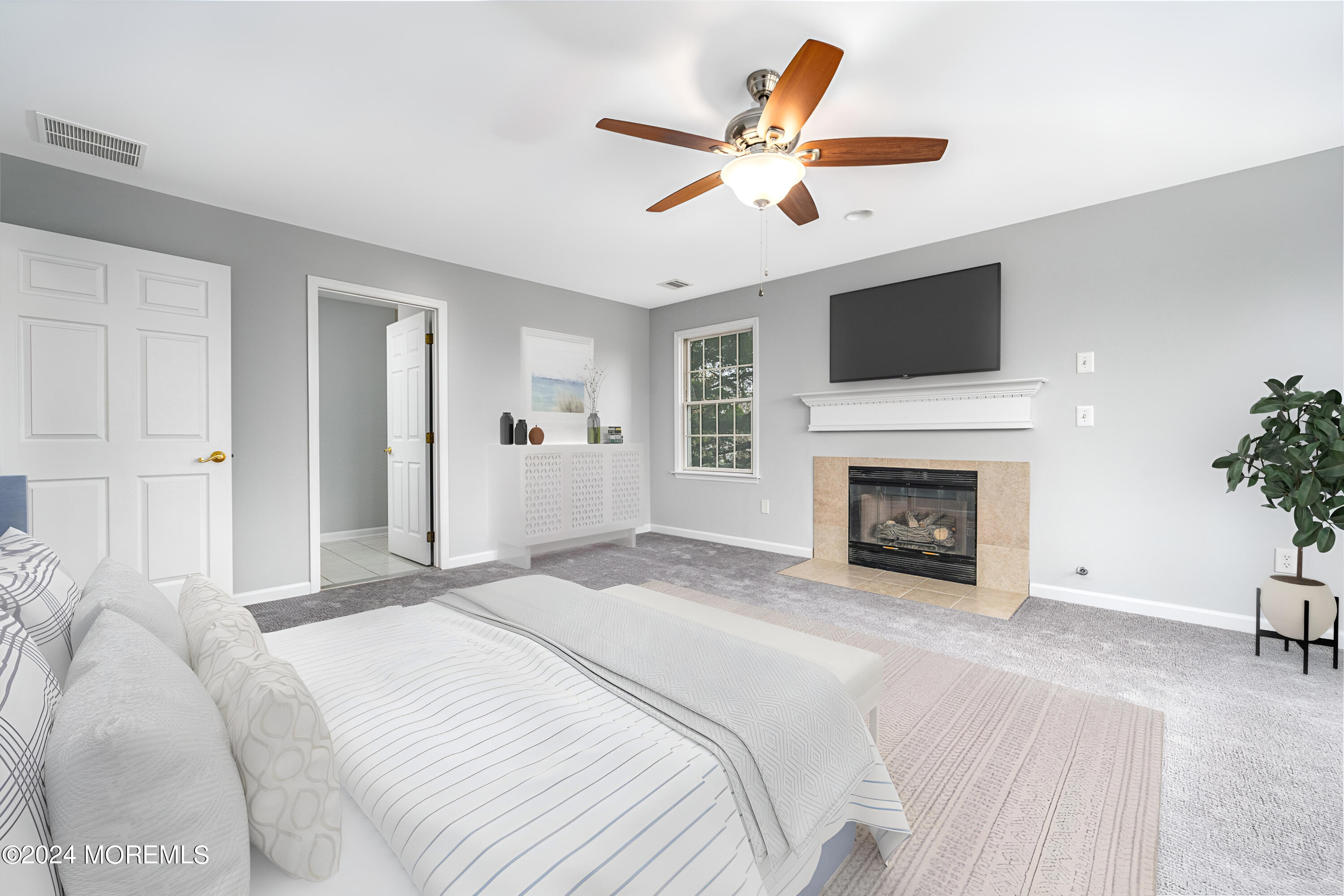 120 Leeward Road Manahawkin, NJ 08050 - Photo 16 of 23 a spacious bedroom with a large bed a fireplace and a flat screen tv