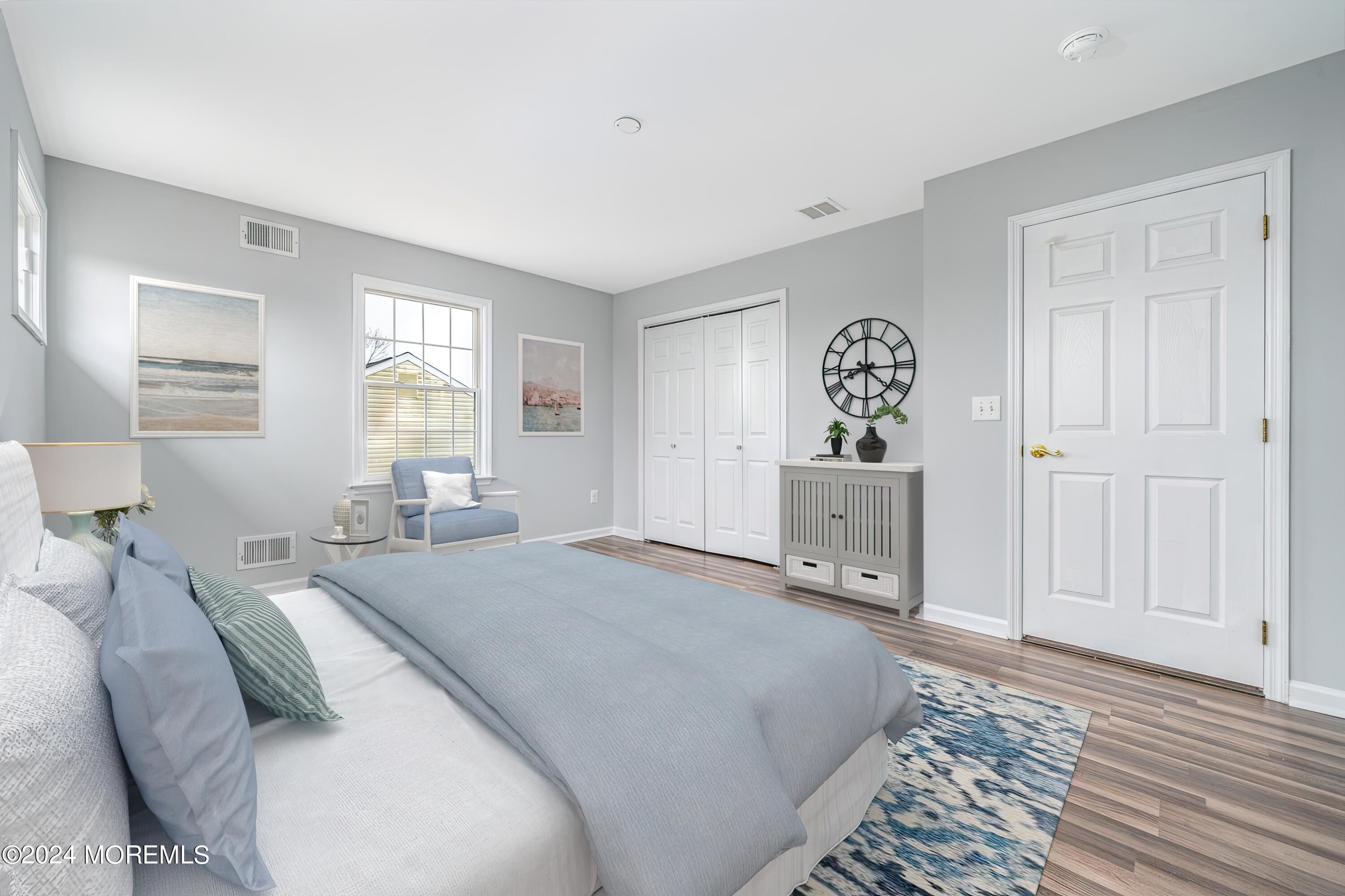 120 Leeward Road Manahawkin, NJ 08050 - Photo 22 of 23 a bedroom with a bed and a chandelier