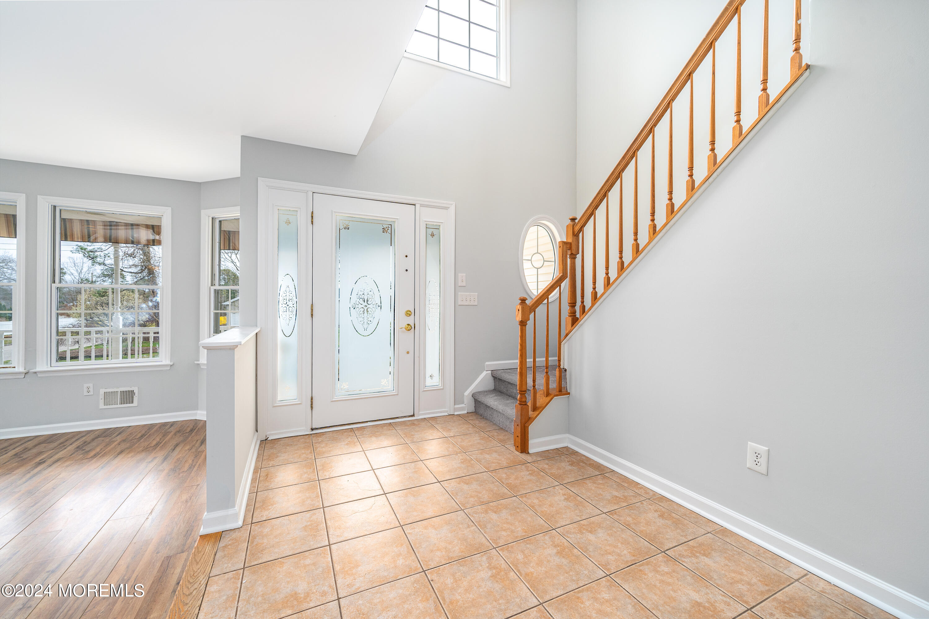 120 Leeward Road Manahawkin, NJ 08050 - Photo 3 of 23 a view of an entryway with wooden floor and windows
