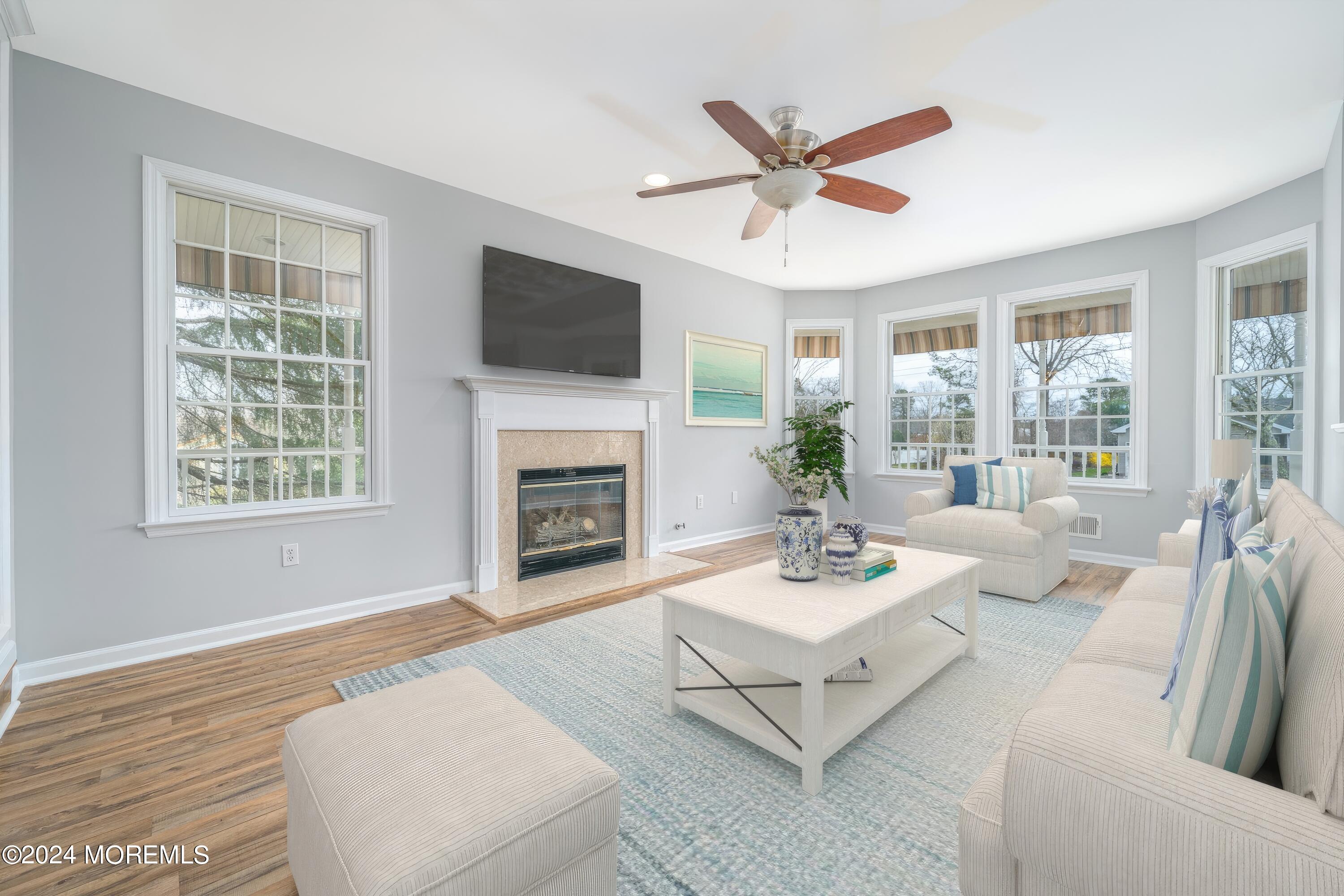 120 Leeward Road Manahawkin, NJ 08050 - Photo 4 of 23 a living room with furniture a fireplace and a flat screen tv