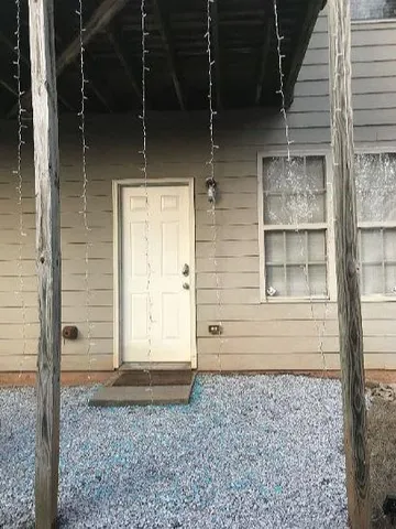 a front view of a house with a yard and trees
