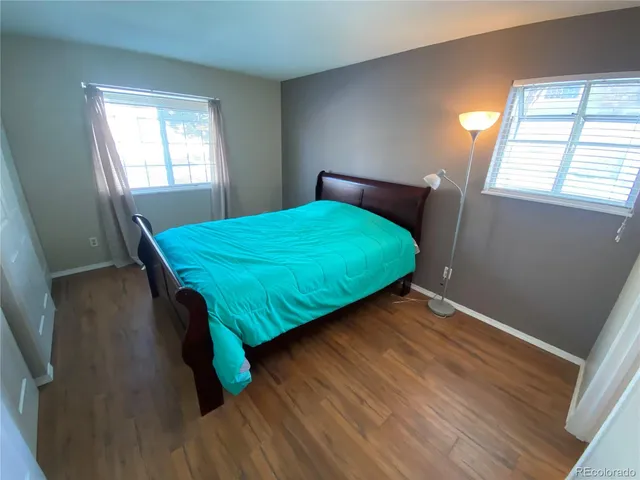 a bed sitting in a bedroom next to a window