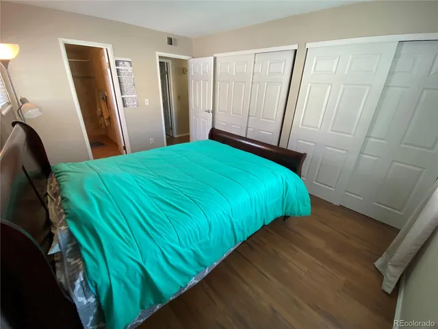 a bedroom with a bed and a mirror