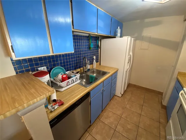 a kitchen with refrigerator and cabinets