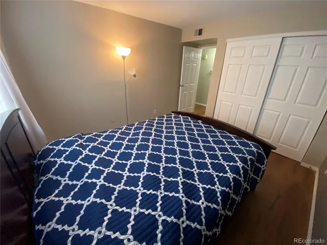 a large bedroom with a mirror