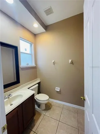 a bathroom with a sink a toilet and mirror