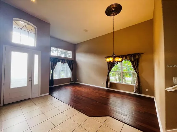 a view of a livingroom with wooden floor and a window