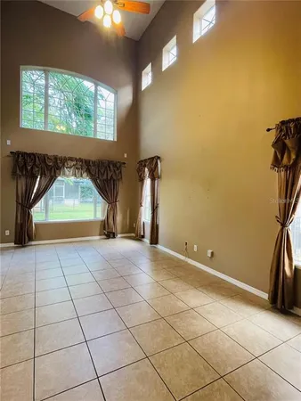 a view of empty room with a fireplace and a floor to ceiling window