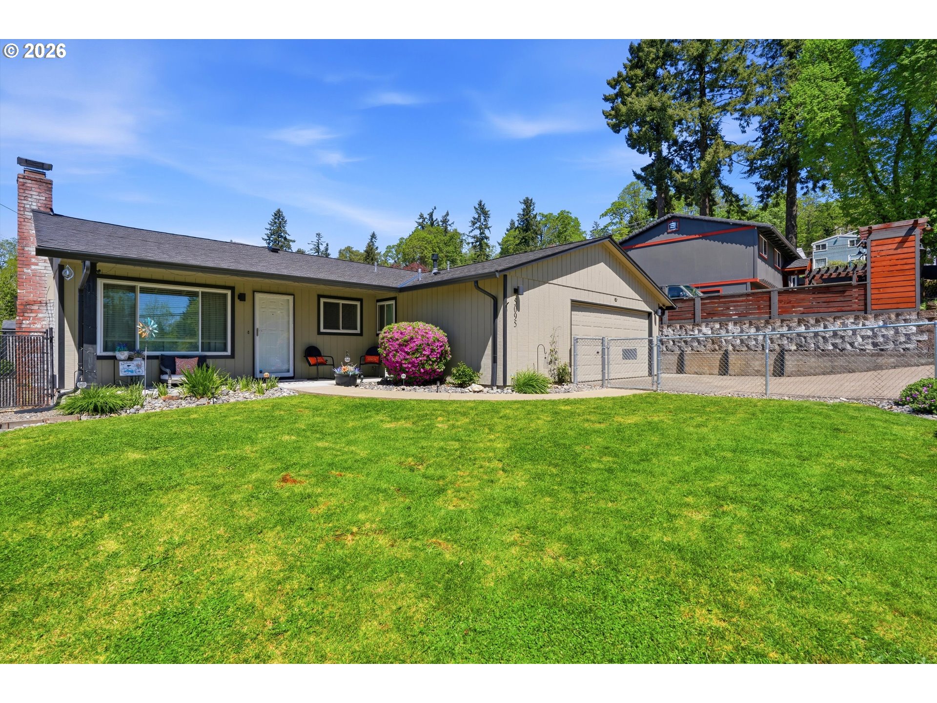 5095 Southeast Roethe Road Milwaukie, OR 97267 - Photo 1 of 28 a front view of a house with garden