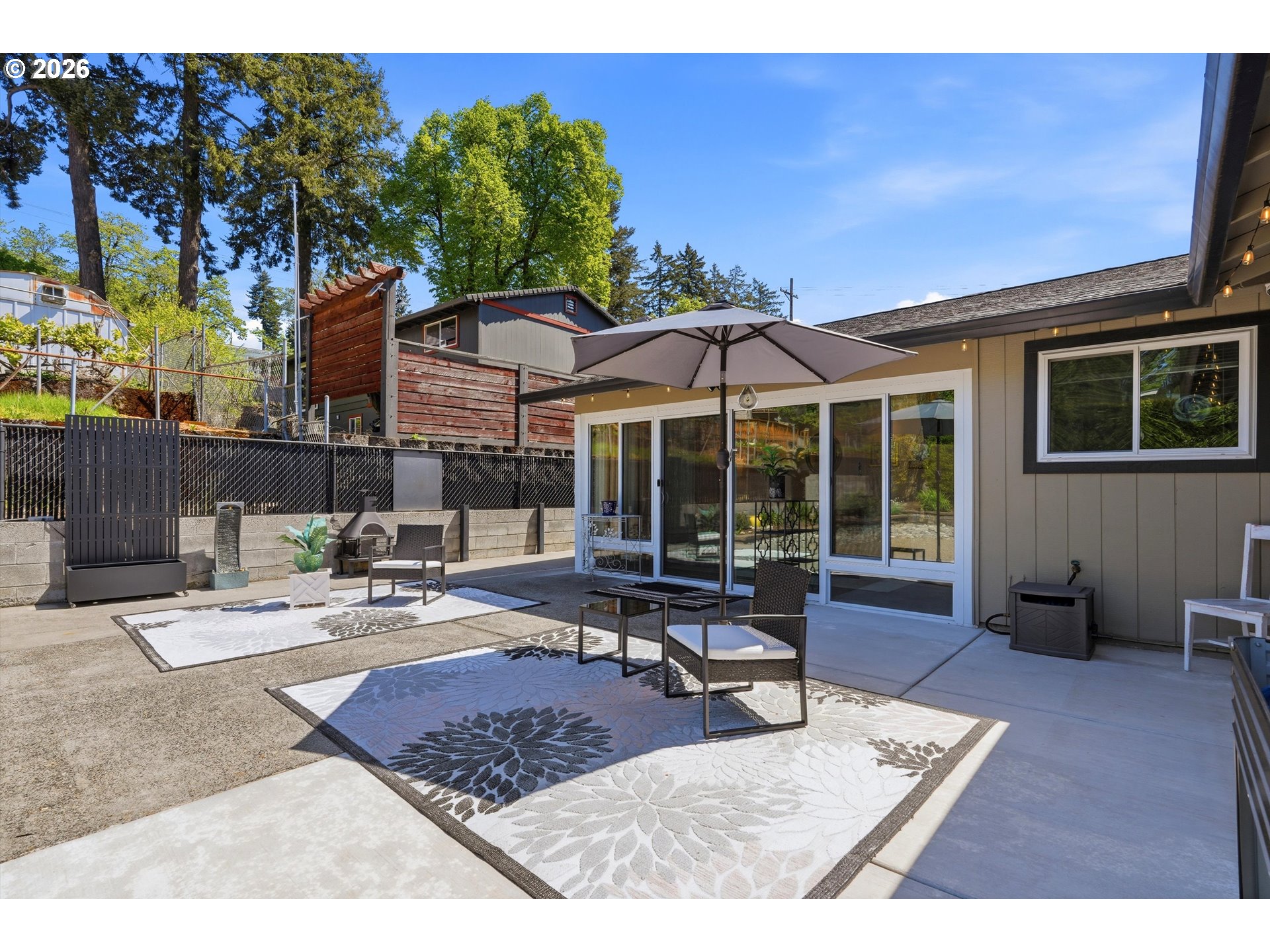 5095 Southeast Roethe Road Milwaukie, OR 97267 - Photo 23 of 28 a building outdoor space with patio furniture and potted plants