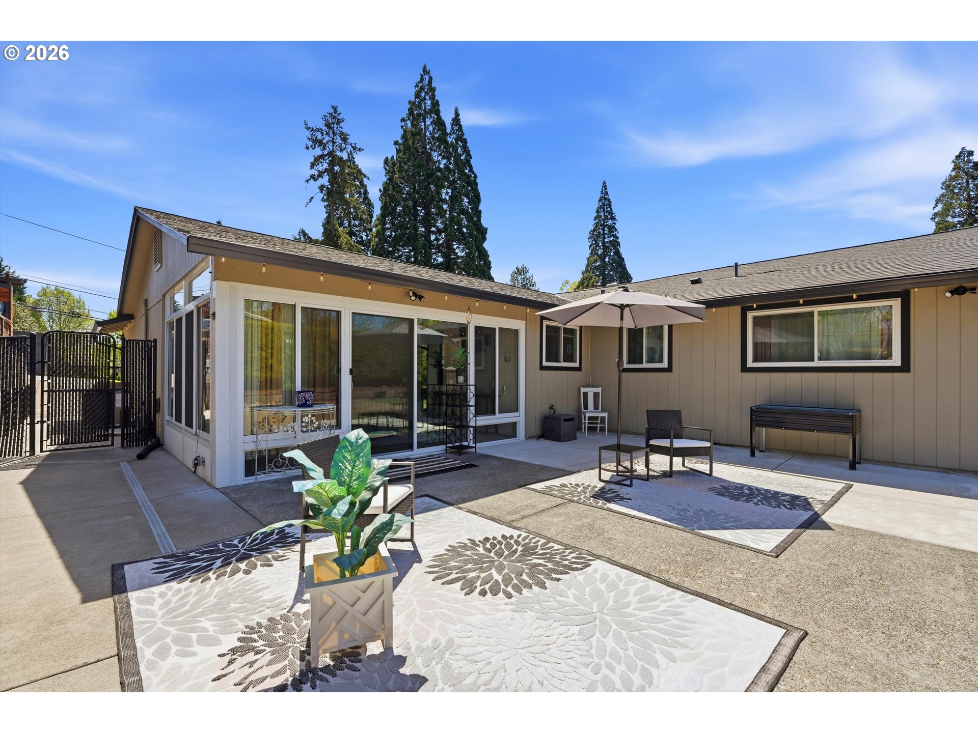 5095 Southeast Roethe Road Milwaukie, OR 97267 - Photo 25 of 28 a view of a patio with table and chairs with wooden floor and fence