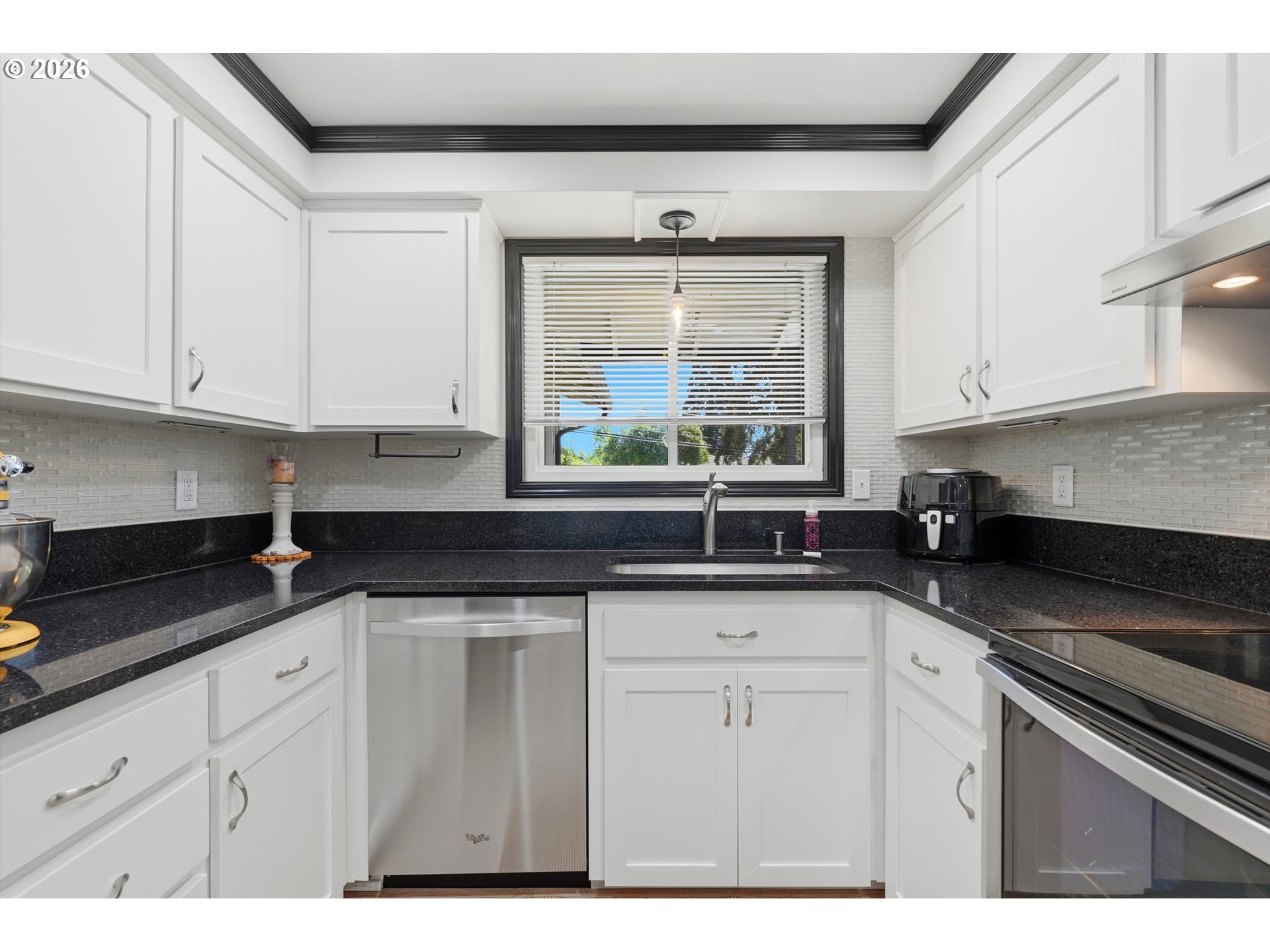 5095 Southeast Roethe Road Milwaukie, OR 97267 - Photo 9 of 28 a kitchen with granite countertop white cabinets and a sink