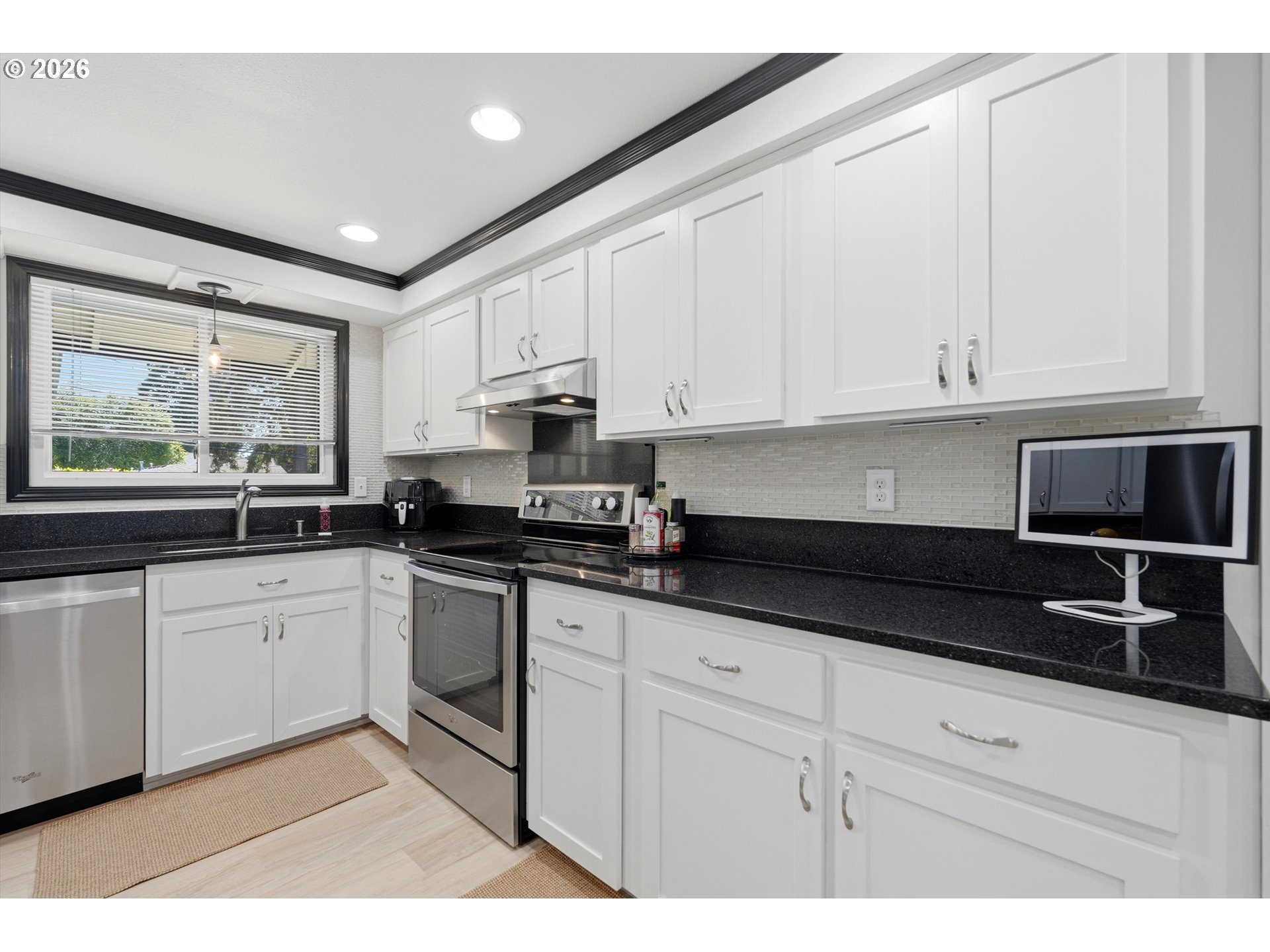 5095 Southeast Roethe Road Milwaukie, OR 97267 - Photo 10 of 28 a kitchen with granite countertop white cabinets and stainless steel appliances