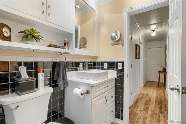 a bathroom with a sink a toilet and a mirror