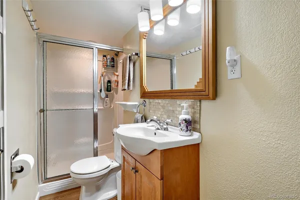 a bathroom with a sink toilet and shower