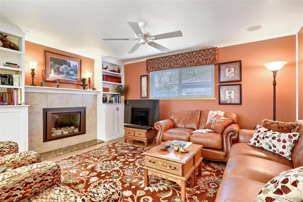 a living room with furniture and a fireplace