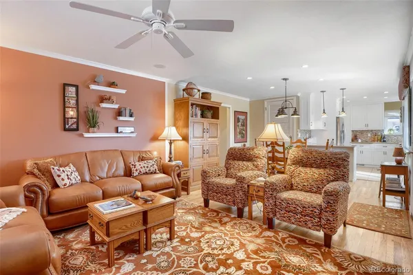 a living room with furniture and a chandelier