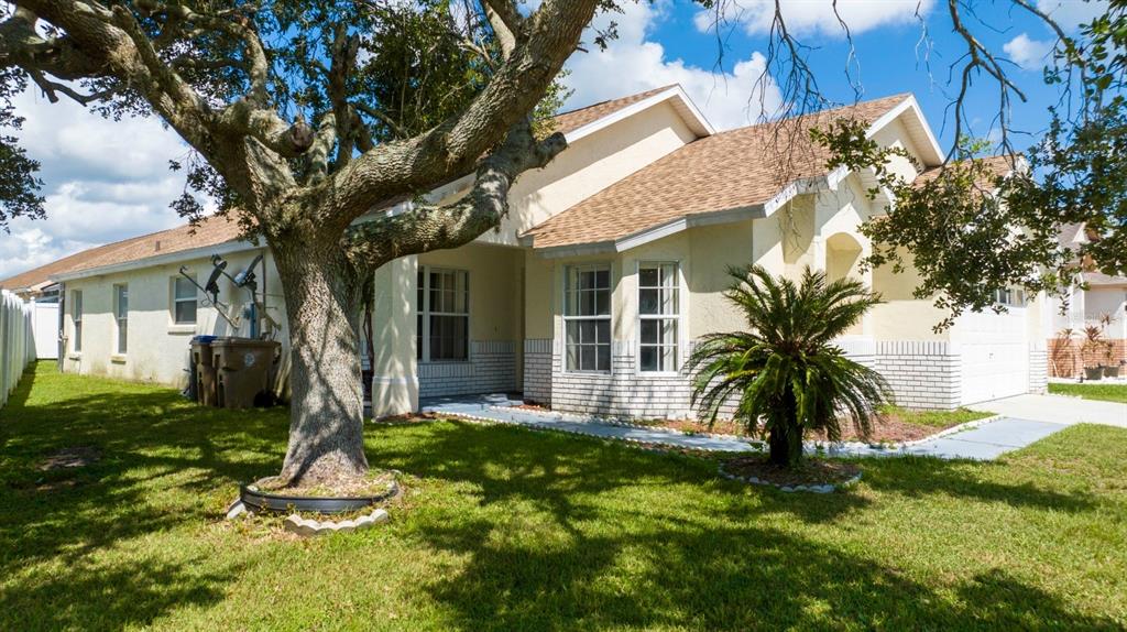 4669 Prairie Point Boulevard Kissimmee, FL 34746 - Photo 1 of 13 a front view of a house with a yard and palm tree