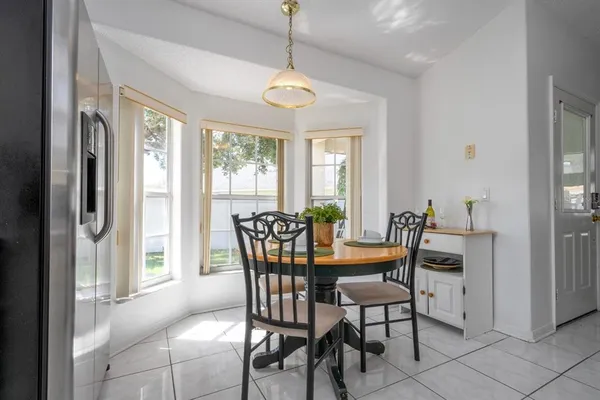 a dining room with furniture a chandelier and wooden floor