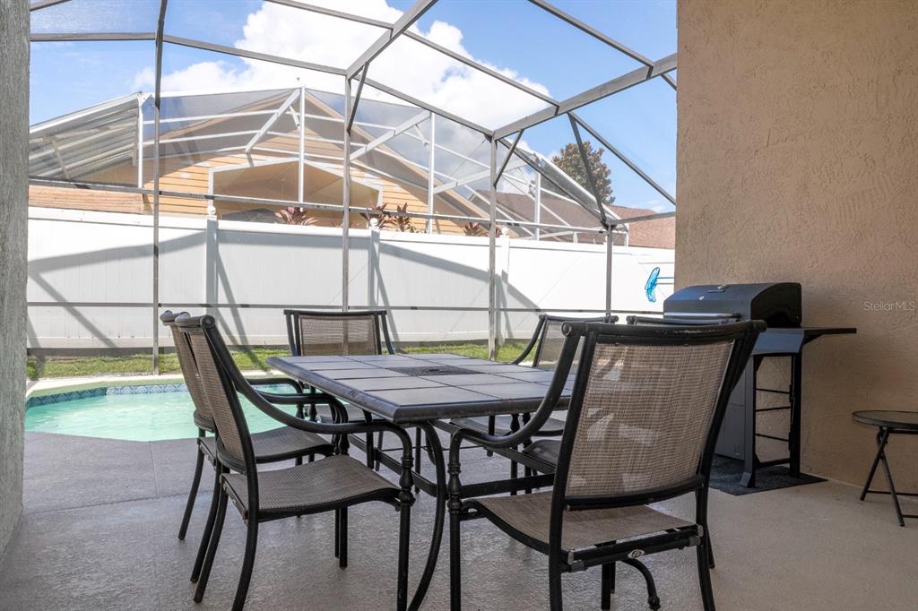 4669 Prairie Point Boulevard Kissimmee, FL 34746 - Photo 4 of 13 a table and chairs with the wooden floor