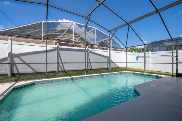 a view of a backyard with swimming pool