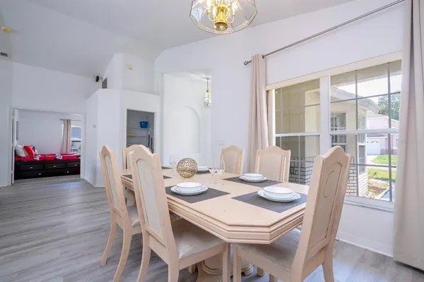 a view of a dining room with furniture and wooden floor