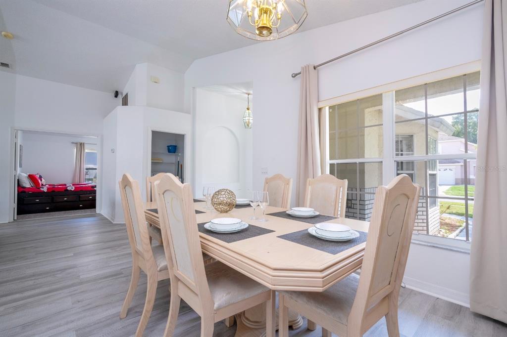 4669 Prairie Point Boulevard Kissimmee, FL 34746 - Photo 6 of 13 a view of a dining room with furniture and wooden floor