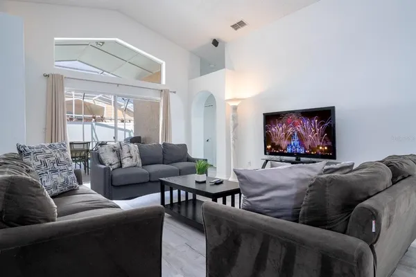 a living room with furniture and a flat screen tv