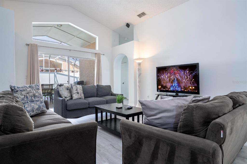 4669 Prairie Point Boulevard Kissimmee, FL 34746 - Photo 7 of 13 a living room with furniture and a flat screen tv