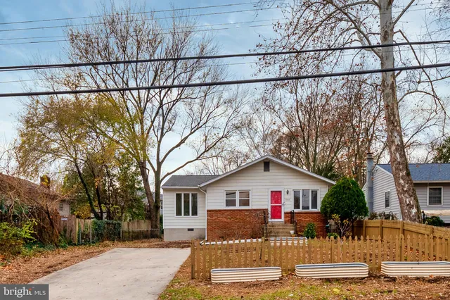 a view of a house with a yard covered in snow