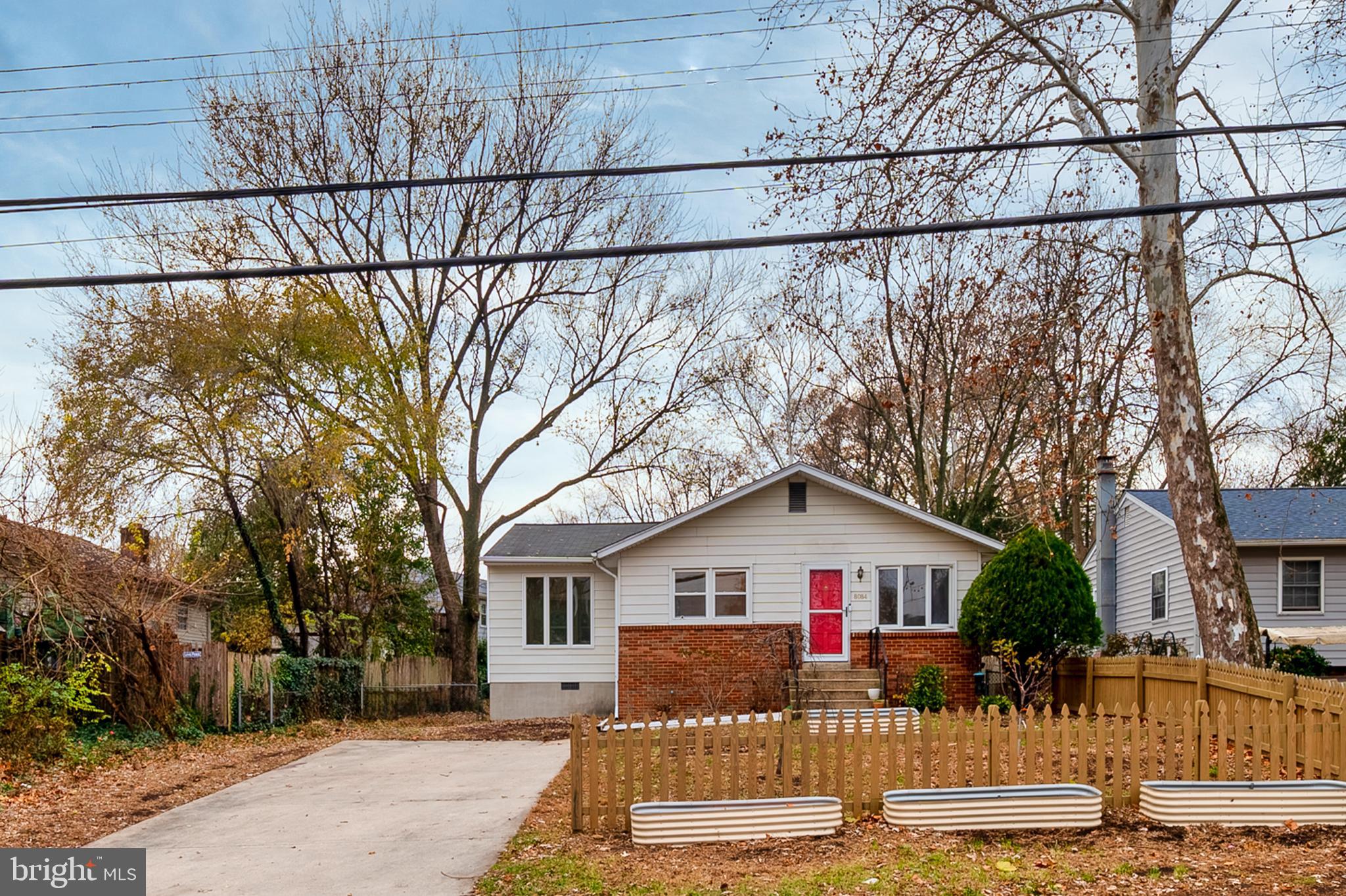 a view of a house with a yard covered in snow