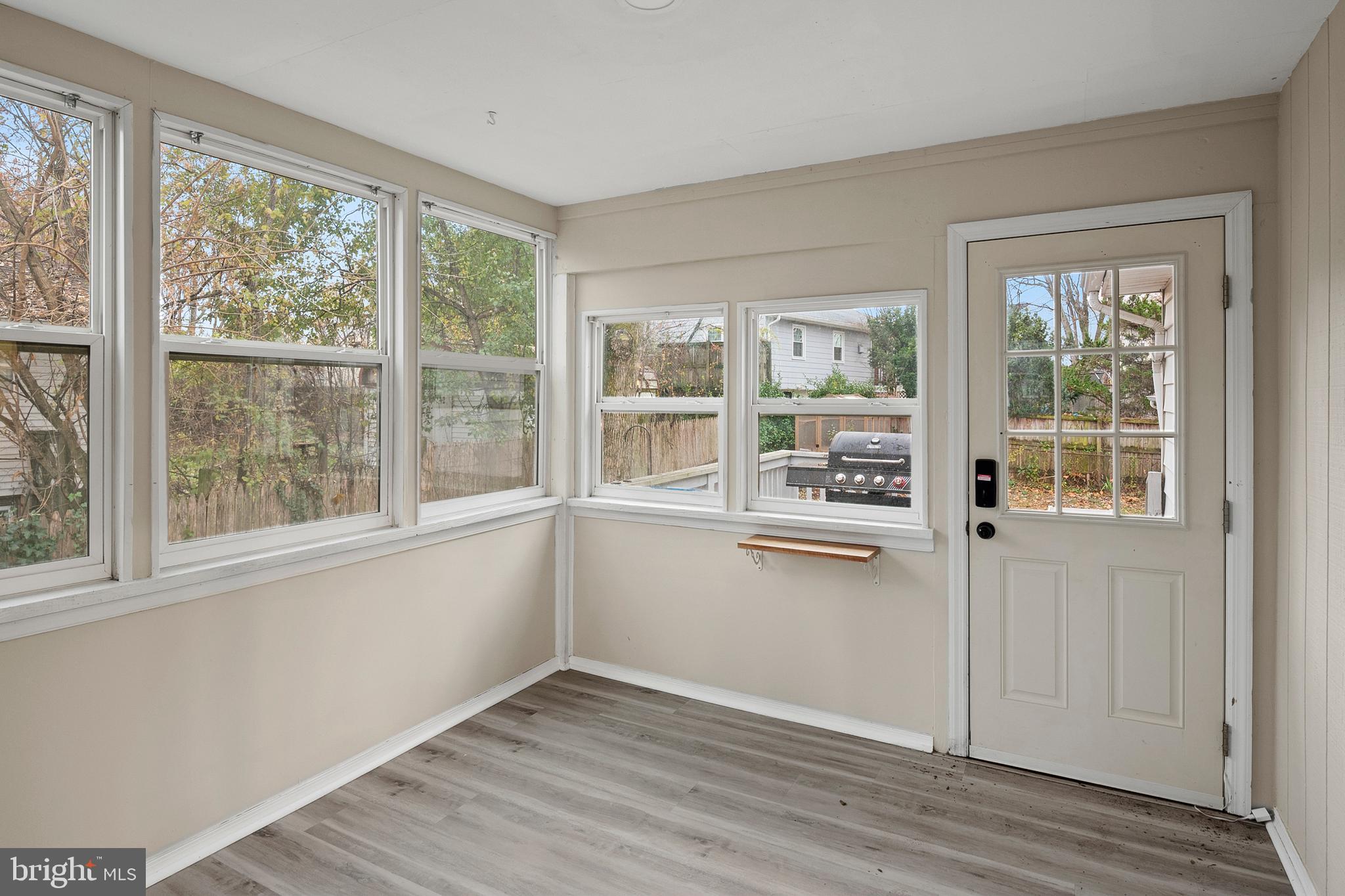 8084 Clark Station Road Severn, MD 21144 - Photo 11 of 36 a view of a kitchen with wooden floor and windows