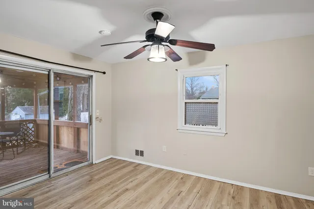 a view of a kitchen with wooden floor and windows