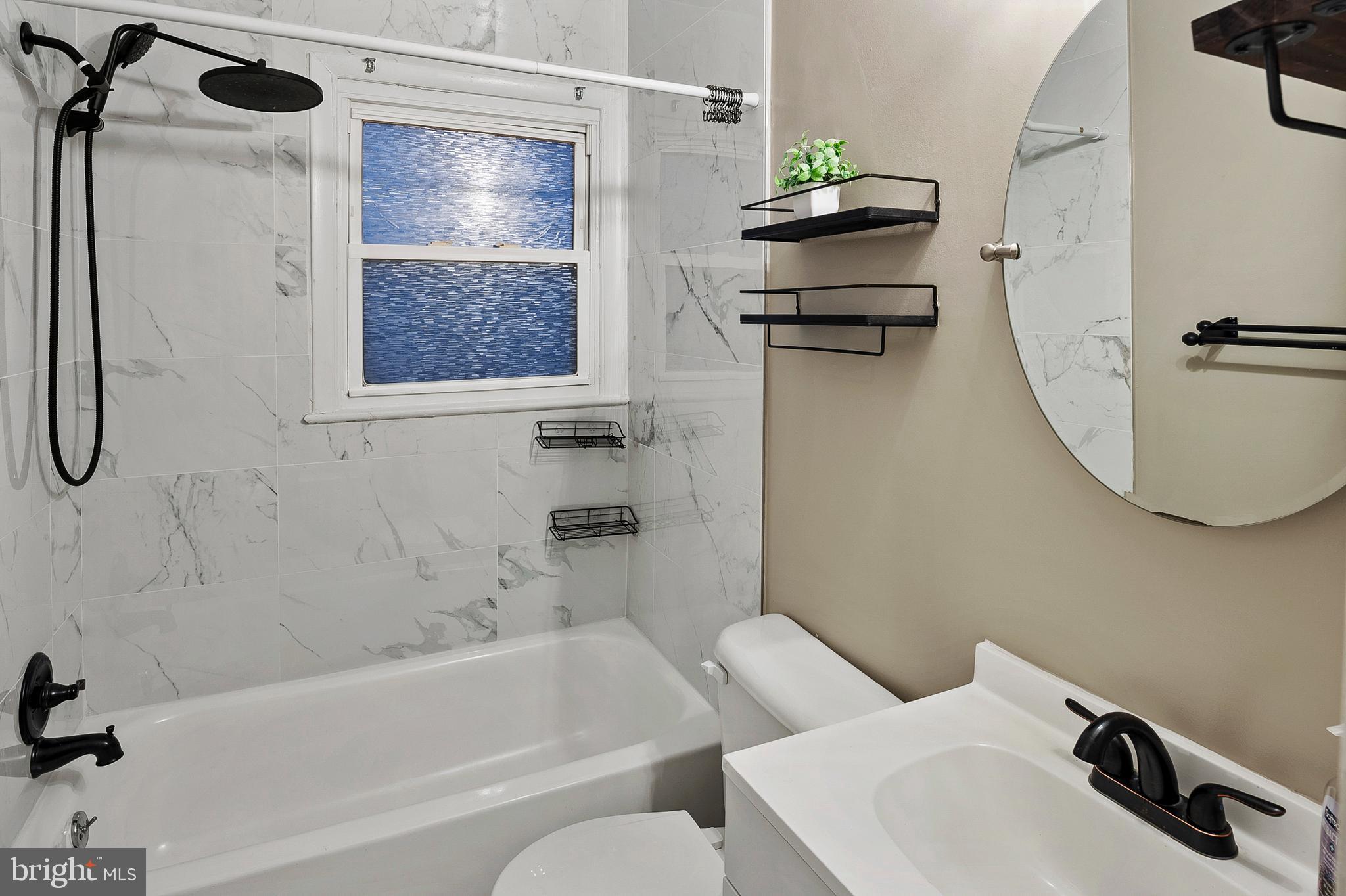 8084 Clark Station Road Severn, MD 21144 - Photo 14 of 36 a bathroom with a sink toilet and shower