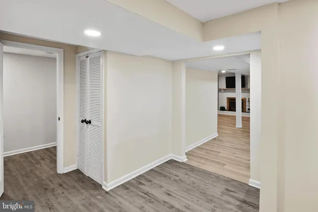 a view of a hallway with wooden floor