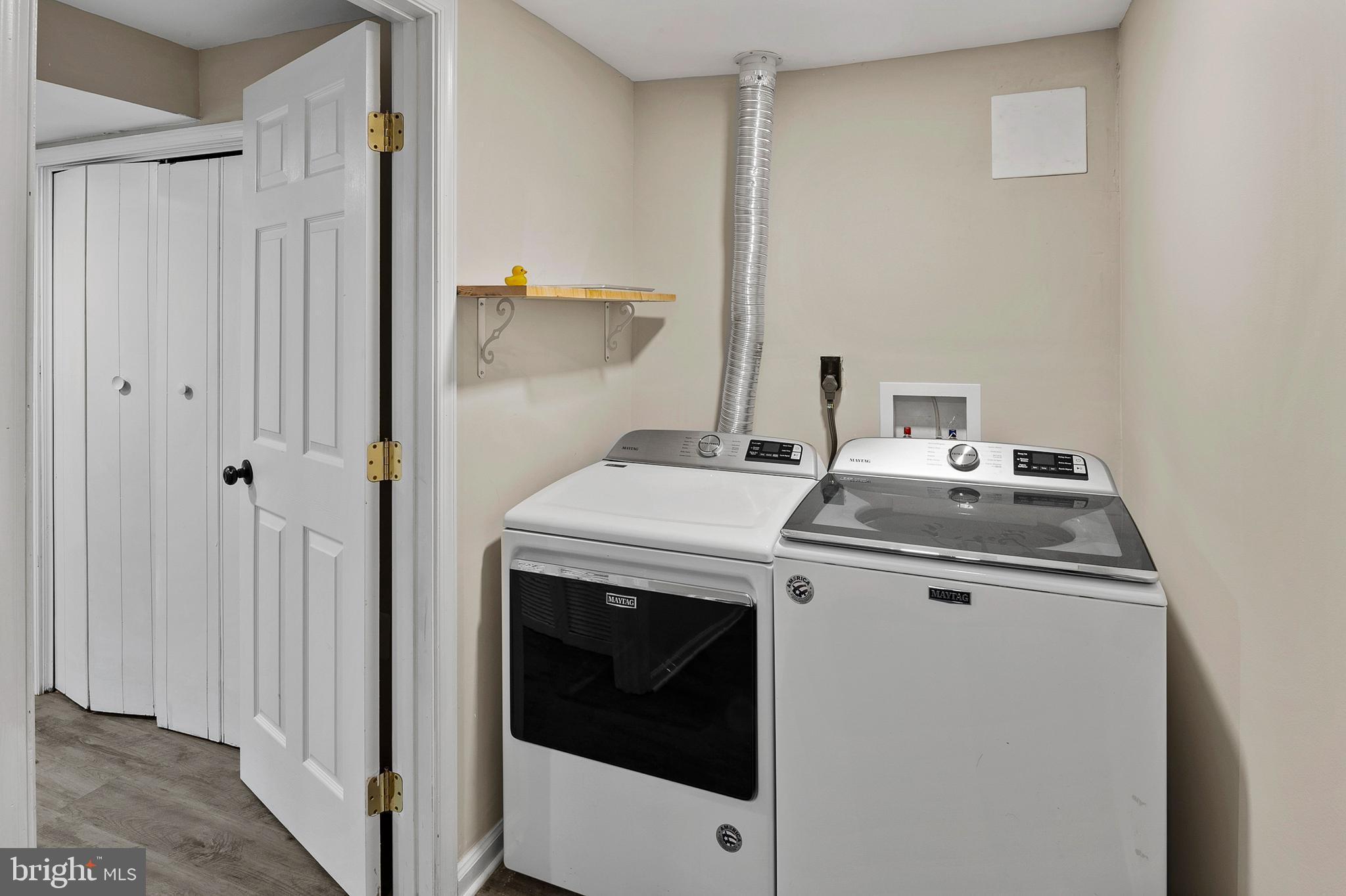 8084 Clark Station Road Severn, MD 21144 - Photo 25 of 36 a view of washer and dryer with wooden floor