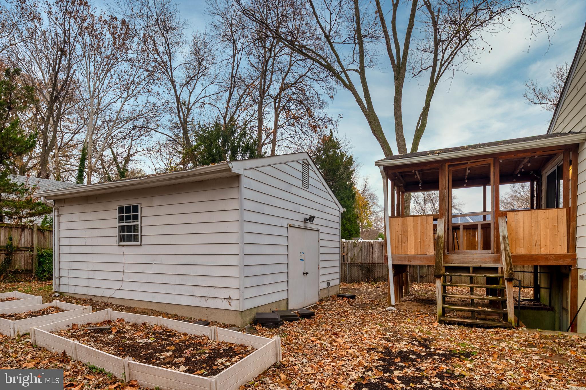 8084 Clark Station Road Severn, MD 21144 - Photo 28 of 36 a backyard of a house with wooden fence table and chairs