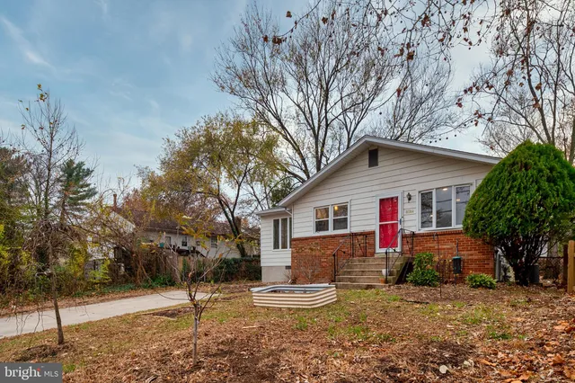 a view of a house with a yard covered in snow