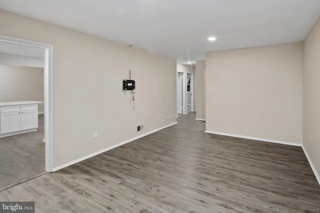 a view of a livingroom with wooden floor and window