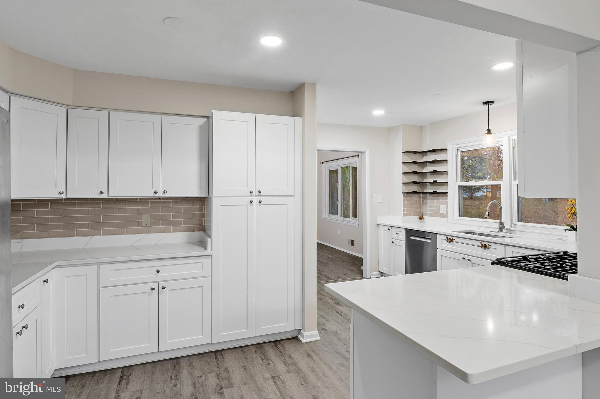 8084 Clark Station Road Severn, MD 21144 - Photo 6 of 36 a kitchen with white cabinets and appliances