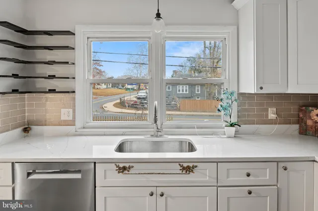 a kitchen with white cabinets and appliances