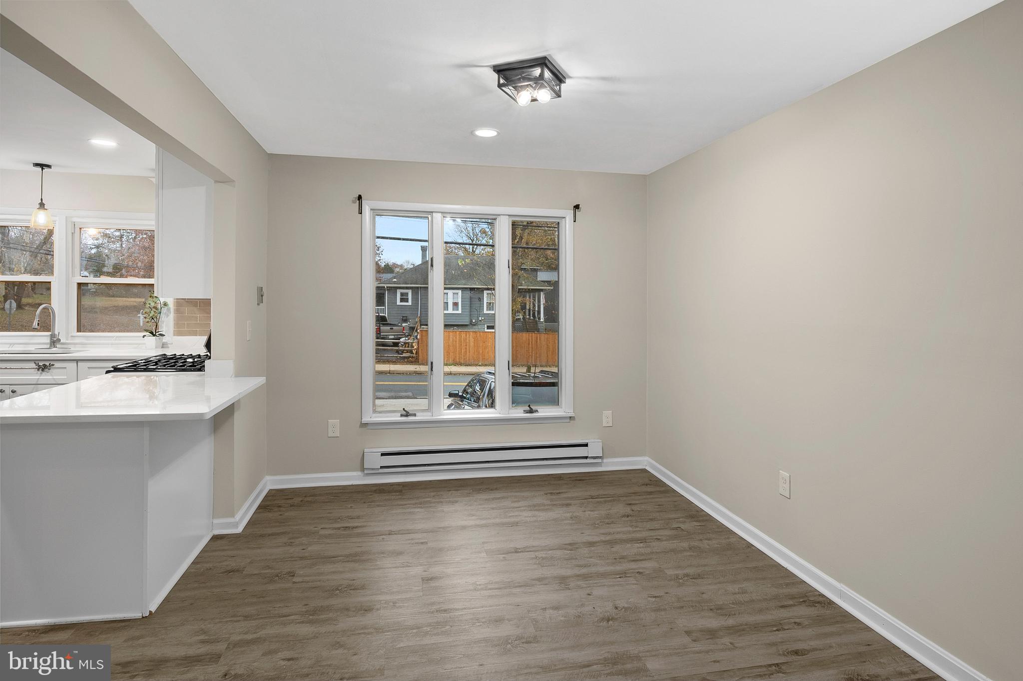 8084 Clark Station Road Severn, MD 21144 - Photo 8 of 36 an empty room with wooden floor and windows